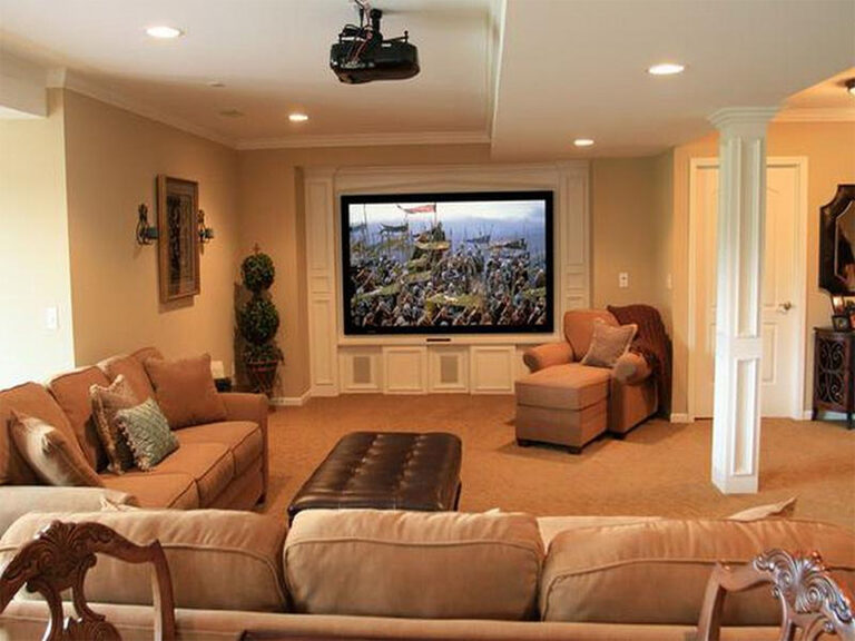 Finished basement living area with recessed lighting and built-in shelving