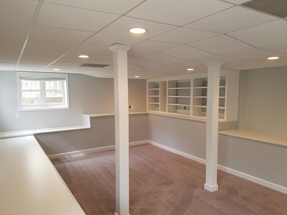 Finished basement with a seating area, recessed lighting and a built-in bar