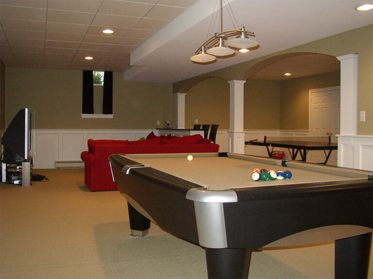 Finished basement game room with a bar area and recessed lighting